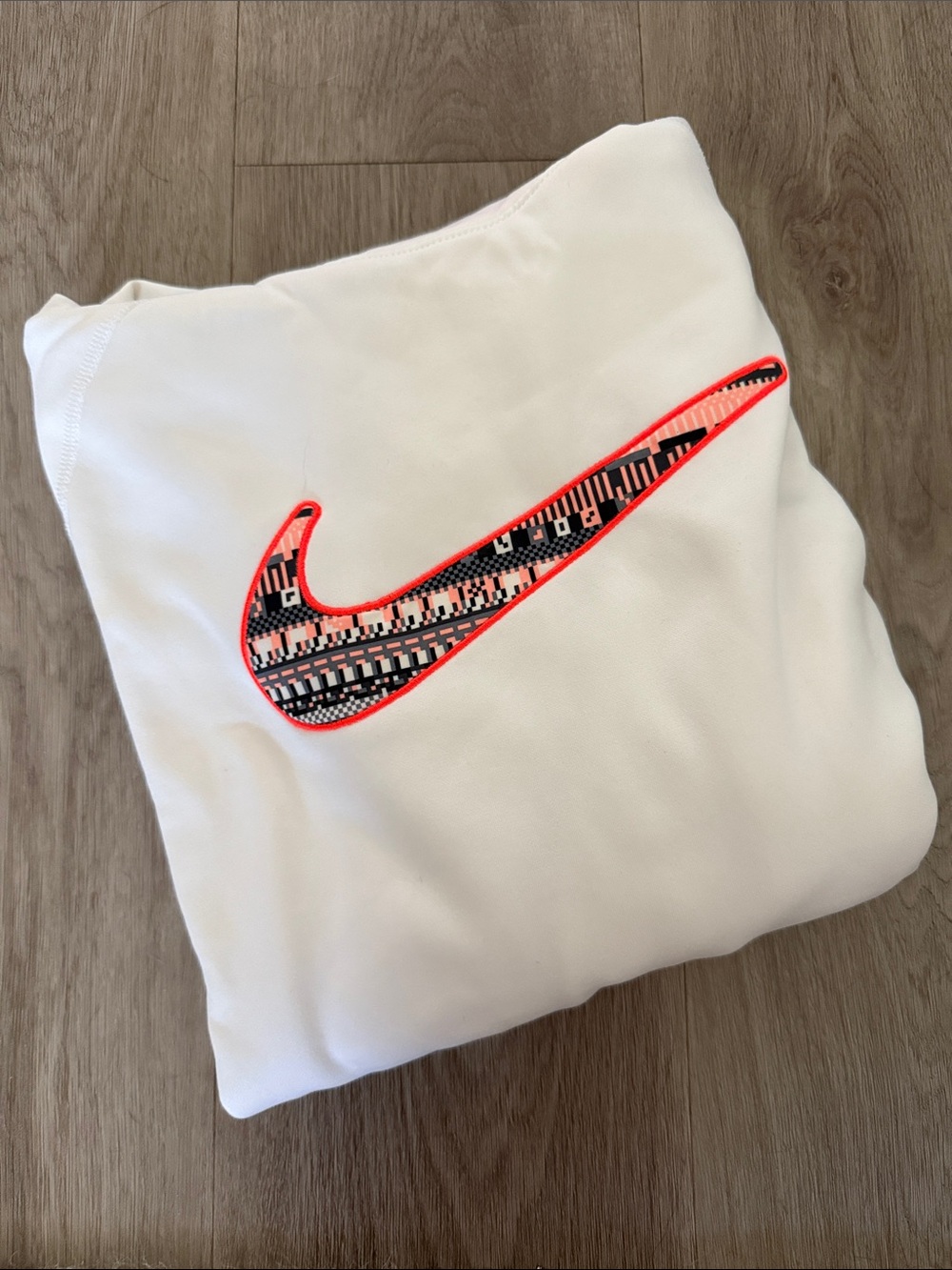 Nike White Sweatshirt with Neon Coral-Outlined Patterned Swoosh